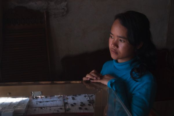 Young lady in a Pailin dealer's shop
