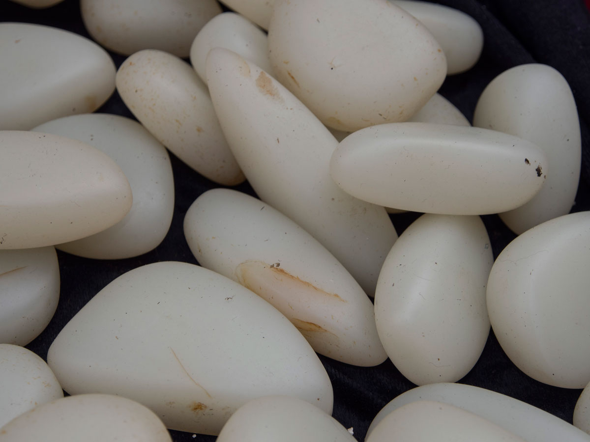 What appears to be Chinese nephrite in Guangzhou's Hualin Street jade market. Some of these feature obvious iron-oxide stains. Lotus Gemology explores jade, nephrite, jade treatments.
