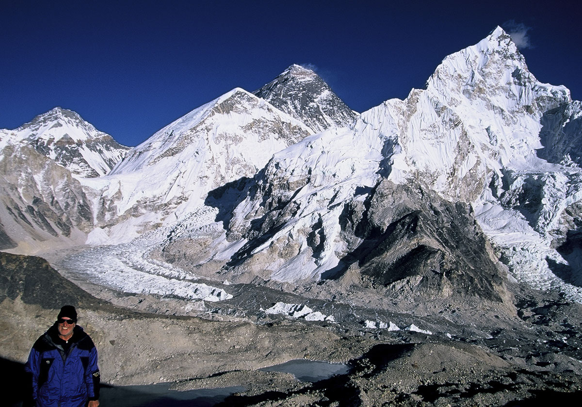 Kala Patar Richard Hughes at Kala Patar above Gorak Shep in Nepal's Khumbu District, with Mt. Everest (center; 8848 m; 29,028 ft) in the background (2003). The author visited Everest from the Nepalese side in 1977 and 2003, but always dreamed of seeing it from the north. The top of Everest (above the yellow band) is actually limestone containing tiny marine fossils. Lhotse (8,414 m; 27,605 ft), fourth highest mountain in the world, dominates the scene to the right of Everest.&nbsp;Photo: Olivier Galibert