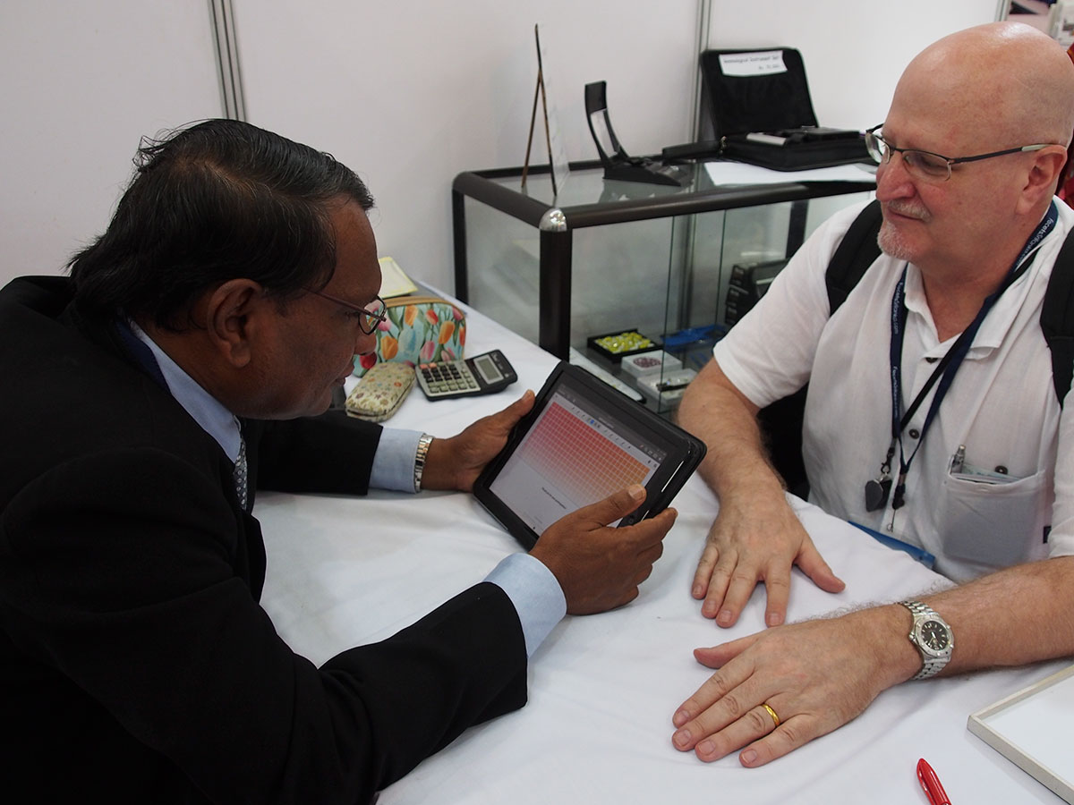 Figure 6. Padparadscha survey Sri Lankan gem expert, Gamini Zoysa (left) taking the padparadscha survey as the author looks on. Photo: Wimon Manorotkul.