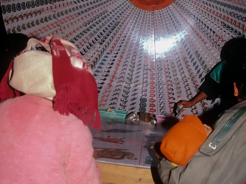 Gambling fever At nightfall, many of the towns of Jade Land morph into miniature Las Vegases. Here an entire family watches a roulette wheel anxiously at Makapin. Note the small child asleep.