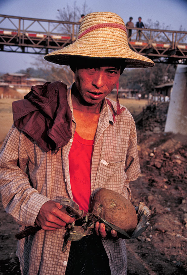 Figure 13. The color of luck Miner with jade at the Uru river tailings dump in the center of Hpakan. Photo © Richard W. Hughes.