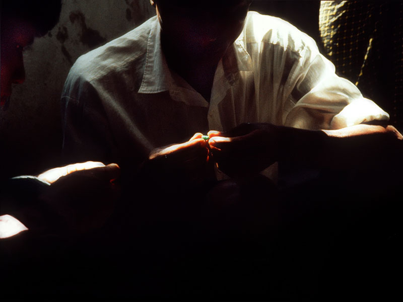 Figure 14. The color of money Examining jadeite in Hpakan. Photo © Olivier Galibert.