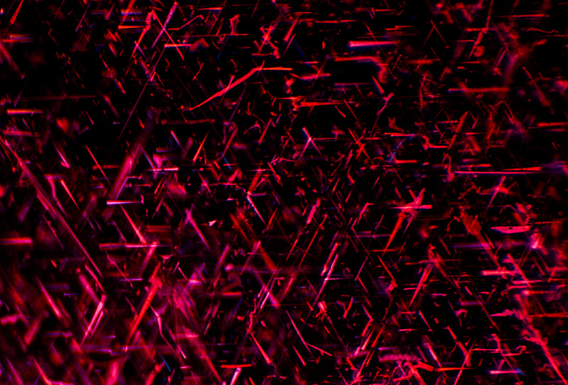 Rutile silk in a Burmese ruby. These inclusions scatter light, helping to reduce extinction