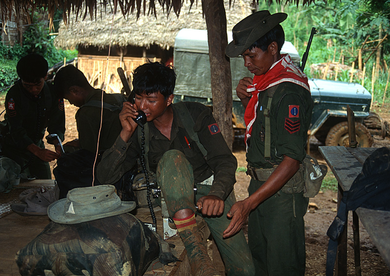 Our military escort radios headquarters from Namlam, deep in Burma's Kachin State.